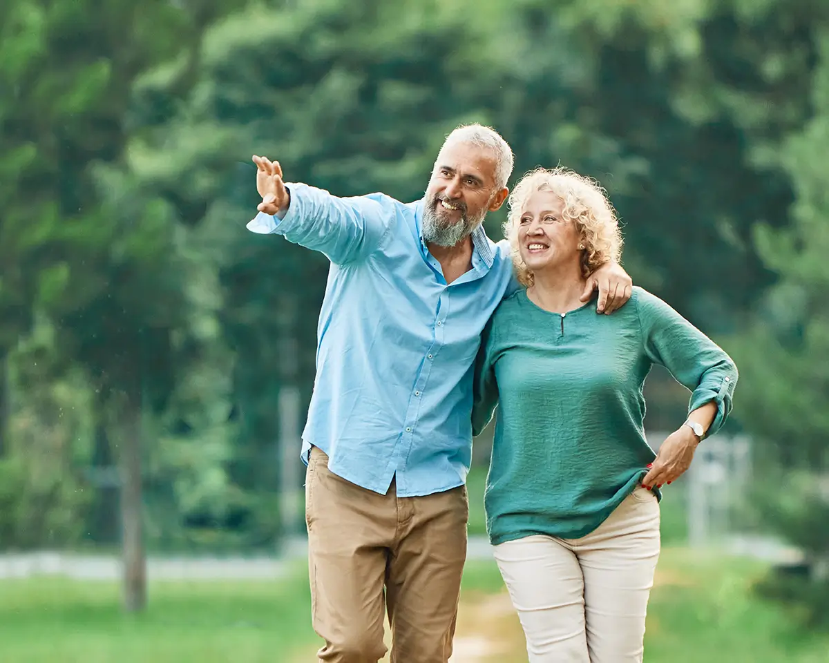 Healthy, active couple in their 50s walking outdoors together